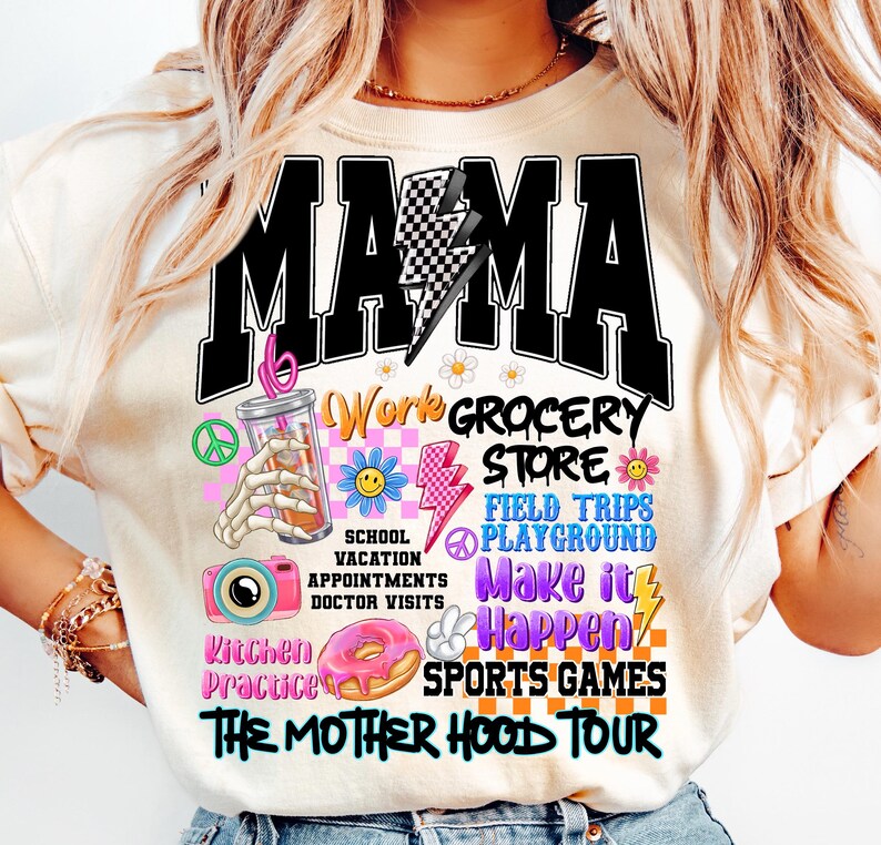 May include: A white t-shirt with a black graphic that says "MAMA" with a lightning bolt and checkered pattern. The graphic also includes images of a peace sign, a donut, a camera, a lightning bolt, a smiley face, a glass of iced coffee, and the text "Work Grocery Store, School Vacation Appointments Doctor Visits, Field Trips Playground, Make it Happen, Kitchen Practice, Sports Games, The Mother Hood Tour."