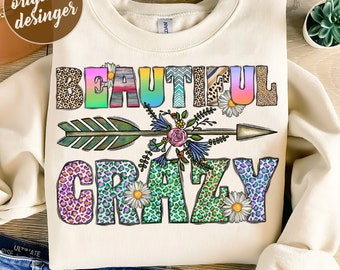 May include: A sublimation design featuring the text "Beautiful Crazy" in a colorful, patterned font. The text is surrounded by a floral design and an arrow.