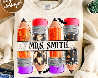 May include: A cream-coloured sweatshirt with a pencil design and Halloween-themed details. The pencils have orange, black, and purple accents, with spiderwebs, ghosts, and bats. The name "MRS. SMITH" is displayed in a banner. The text "300 DPI SUBLIMATION DESIGNS PNG FILE" is at the bottom.
