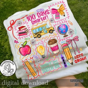 May include: White t-shirts with colorful school-themed graphics. Designs include a school bus, apple, globe, pencils, and the text "100 Days Smarter!" and "Let's Grow!" The shirts are stacked on a green grassy surface.