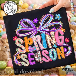 May include: Black t-shirt with the words "SPRING SEASON" in colorful, patterned letters. A large purple bow and floral accents surround the text. The words "digital download" are at the bottom, and the FarmDreamArt logo is in the corner.