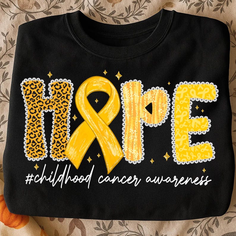 May include: Black sweatshirt with the word "HOPE" in yellow and leopard print. A yellow ribbon is in the center. The text "#childhood cancer awareness" is written below the word "HOPE".