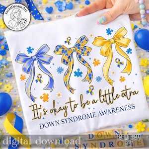 May include: White t-shirt with three decorative bows in blue and yellow, with puzzle pieces and the text "It's okay to be a little extra. Down Syndrome Awareness." The design includes the words "digital download" and the FarmDreamArt logo.