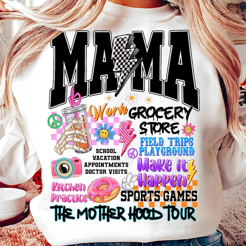 May include: White sweatshirt with a black graphic design that says "MAMA" with a lightning bolt and checkered pattern. The graphic also includes the text "Work Grocery Store", "School Vacation Appointments Doctor Visits", "Field Trips Playground Make it Happen", "Kitchen Practice Sports Games", and "The Mother Hood Tour".