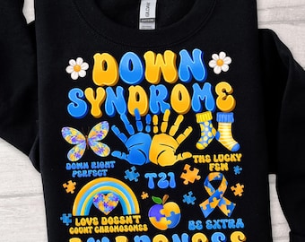 May include: Black sweatshirt with a colorful graphic design that says "Down Syndrome Awareness". The graphic includes handprints, butterflies, puzzle pieces, a rainbow, an apple, and the text "Down Right Perfect", "The Lucky Few", "T21", "Love Doesn't Count Chromosomes", and "Be Extra".