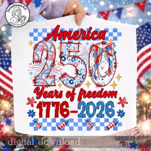 May include: White graphic design featuring the text "America 250 Years of freedom 1776-2026". The design incorporates red, white, and blue elements, including fireworks, stars, and a bow, celebrating the anniversary.