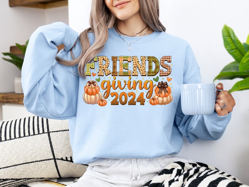 May include: Light blue sweatshirt with a graphic design of pumpkins and the text "FRIENDS giving 2024".