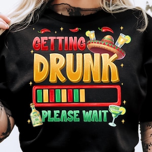 May include: Black t-shirt with a graphic design that says "Getting Drunk - Please Wait" with a progress bar and a sombrero. The graphic also includes a bottle of tequila, a margarita glass, and chili peppers.