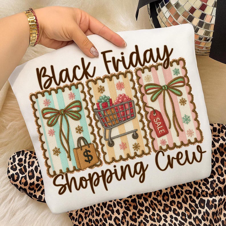 May include: White sweatshirt with the text "Black Friday Shopping Crew." The design features three rectangular images with bows, shopping carts, and gift boxes. The sweatshirt is decorated with snowflakes and a shopping bag.