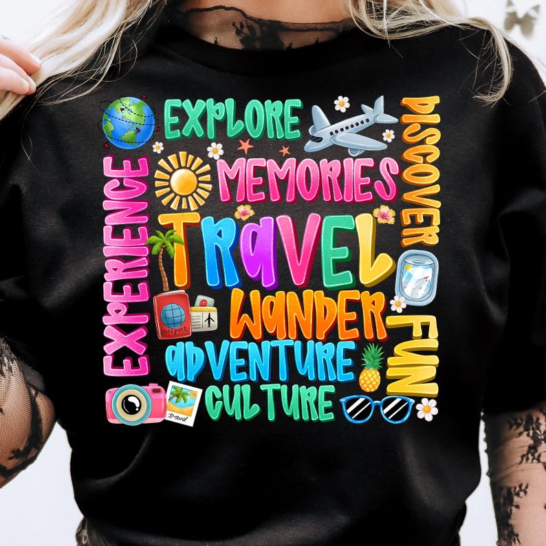 May include: Black t-shirt with colorful text that says "Experience Explore Memories Travel Wander Adventure Culture Discover Fun". The text is surrounded by images of a globe, airplane, sun, palm tree, camera, sunglasses, pineapple, and flowers.