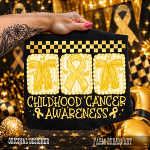 May include: A black t-shirt featuring a gold checkered border at the top and three square panels. The outer panels display gold bows, while the center panel shows a gold awareness ribbon. The text reads CHILDHOOD CANCER AWARENESS.