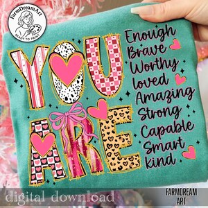 May include: Teal-colored graphic featuring the words "YOU ARE" in a mix of patterns, including hearts, leopard print, and a bow. The words "Enough, Brave, Worthy, Loved, Amazing, Strong, Capable, Smart, Kind" are also displayed. The text "digital download" is at the bottom.