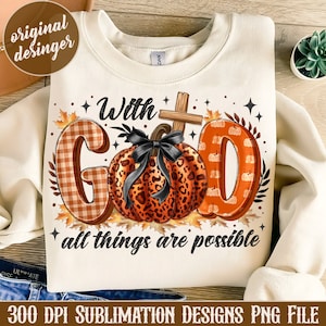 May include: A white sweatshirt with a design featuring the words "With God all things are possible" in black text. The design also includes a pumpkin with a leopard print pattern and a cross.