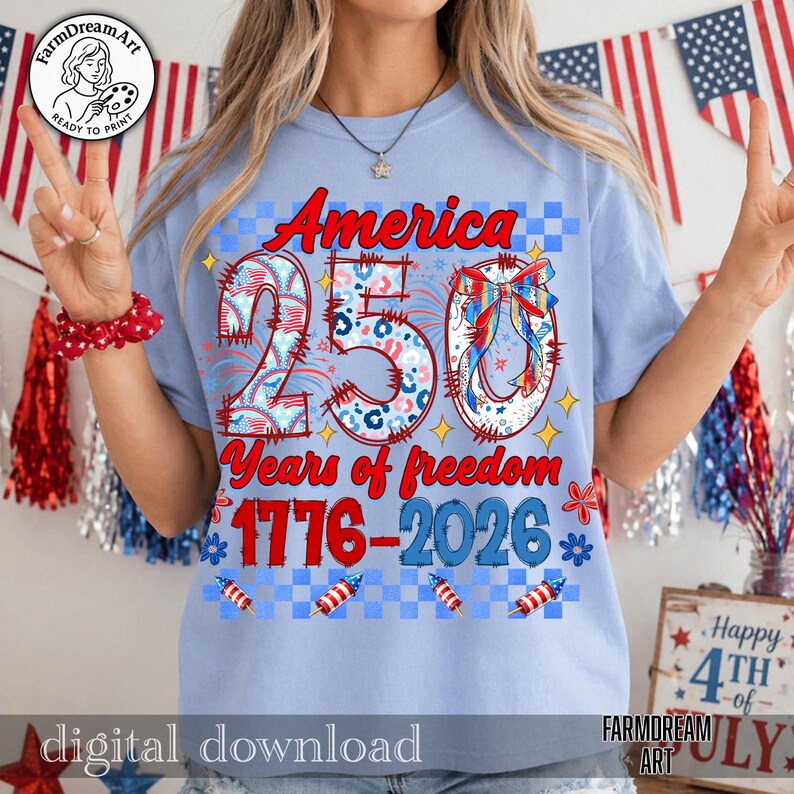 May include: Light blue t-shirt with the text "America 250 Years of freedom 1776-2026" in red and blue. The design includes fireworks, stars, and the number 250 in a patriotic style. The shirt is a digital download.