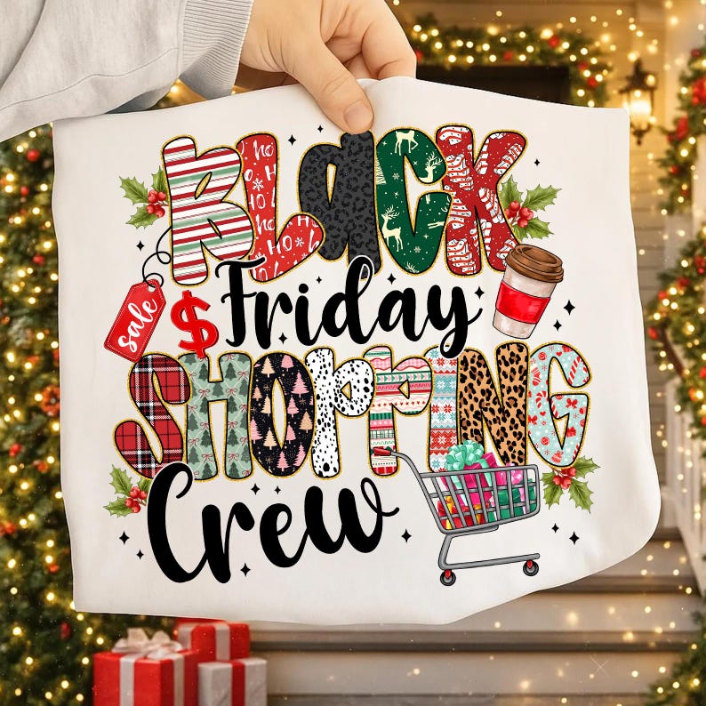 May include: White t-shirt with a colorful "Black Friday Shopping Crew" graphic. The design includes a shopping cart, coffee cup, and the word "Sale" on a tag. The letters are decorated with various patterns.