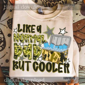May include: A beige sweatshirt with the text "LIKE A NORMAL DAD BUT COOLER" in green camouflage lettering. The design includes a cooler with blue cans and ice, plus star accents. The sweatshirt is a digital download.