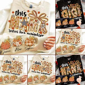 May include: Beige sweatshirt with the text "this MAMA loves her pumpkins" in a fall-themed design. The sleeves feature pumpkin graphics and names. Other sweatshirts say "GIGI", "AUNT", "NANA", and "GRANDMA".
