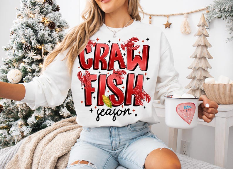 May include: White sweatshirt with red text that says "Crawfish season" with red crawfish illustrations.