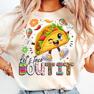 May include: A white t-shirt with a colorful graphic of a smiling taco holding maracas. The text "Let's taco bout it" is written below the taco in colorful letters.