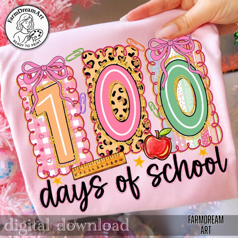 May include: Pink t-shirt featuring a colourful "100 days of school" design. The design includes the numbers 1, 0, and 0, a red apple, a ruler, and the text "days of school". The words "digital download" are also visible.