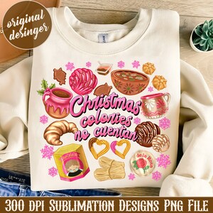 May include: A white sweatshirt with a Christmas-themed design featuring a variety of Mexican treats, including pan dulce, hot chocolate, and candy. The text "Christmas calories don't count" is written in pink letters.