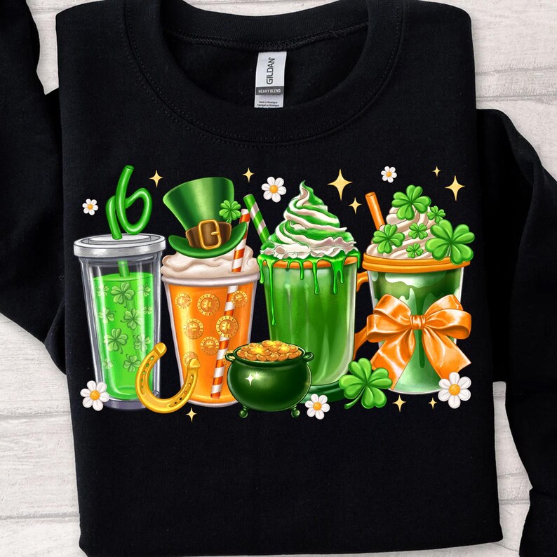 May include: A black sweatshirt with a graphic of four green, orange, and white drinks with shamrocks and a pot of gold. The drinks are labeled "Irish Coffee", "Shamrock Shake", "Green Beer", and "Lucky Charms".