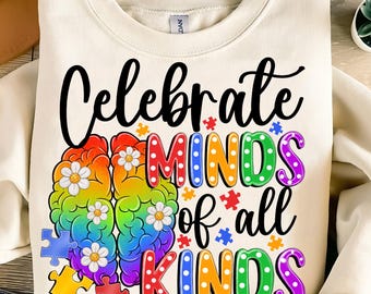 May include: A white sweatshirt with the text "Celebrate Minds of all Kinds" in black and rainbow colors. The text is surrounded by a rainbow brain and puzzle pieces.