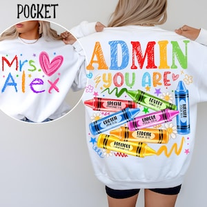 May include: White sweatshirt with colorful text and crayon graphics. The front features "Mrs. Alex" with a heart. The back says "ADMIN YOU ARE" with crayons labeled "Special", "Chosen", "Lovely", "Unique", "Strong", "Precious", and "Blessed".