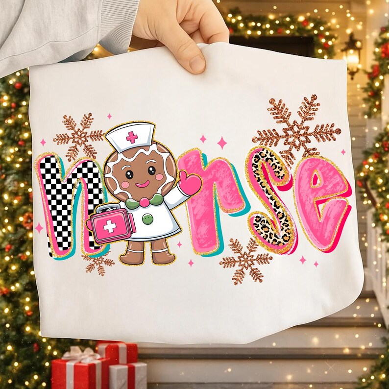 May include: White tote bag featuring the word "Nurse" in pink, with a gingerbread nurse character and snowflake accents. The "N" has a black and white checkered pattern, and the "S" has a leopard print design. A cute and festive design.