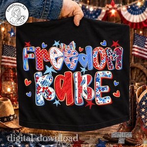 May include: Black t-shirt with the words "Freedom Babe" in red, white, and blue lettering. The design includes stars, hearts, and floral patterns, evoking a patriotic theme. The words "digital download" and "Farmdream Art" are also visible.