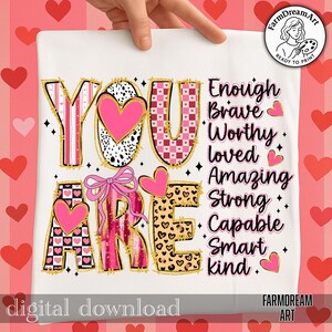 May include: A white digital download featuring the words "YOU ARE" in a variety of patterns, including pink hearts, checkered designs, and leopard print. The words "Enough, Brave, Worthy, Loved, Amazing, Strong, Capable, Smart, Kind" are also displayed.