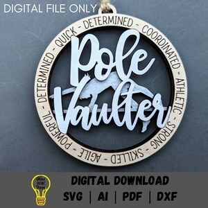 May include: A round wooden ornament featuring a silver silhouette of a pole vaulter. The ornament is decorated with the words "Pole Vaulter" and a list of positive attributes, including "determined", "quick", "coordinated", "athletic", "strong", "skilled", "agile", and "powerful".