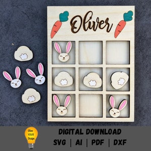 May include: A wooden tic-tac-toe game with a bunny and cloud theme. The game board is personalized with the name "Oliver".