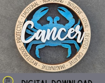 May include: A wooden Cancer zodiac sign ornament with a blue crab design. The word "Cancer" is in white script. The ornament has a natural wood finish and is surrounded by words like "Emotional" and "Intuitive". The words "Digital File" and "Digital Download" are also visible.