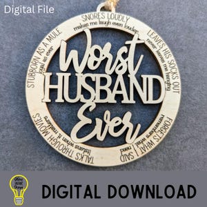 May include: A wooden ornament with the words "Worst Husband Ever" in a circular design. The ornament has a natural wood finish and includes phrases like "Snores loudly" and "Leaves his socks out."