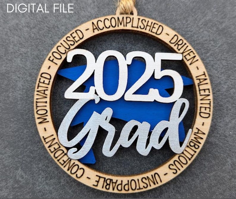 May include: A wooden ornament with a blue and white graduation cap design. The ornament features the year "2025" and the word "Grad" in a silver script font. The ornament is surrounded by a circle of text that reads "Motivated - Focused - Accomplished - Driven - Talented - Ambitious - Unstoppable - Confident".