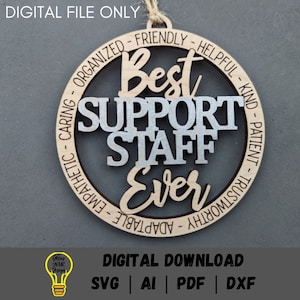 May include: A round wooden ornament with the text "Best Support Staff Ever" in silver lettering. The ornament is decorated with a circle of words describing positive qualities, such as "Friendly", "Helpful", "Kind", "Patient", "Trustworthy", "Adaptable", "Empathetic", "Caring", "Organized".