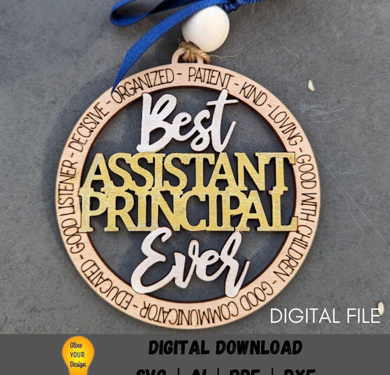 May include: A round wooden ornament with the text "Best Assistant Principal Ever" in gold and white lettering. The ornament is decorated with a blue ribbon and a white bead.