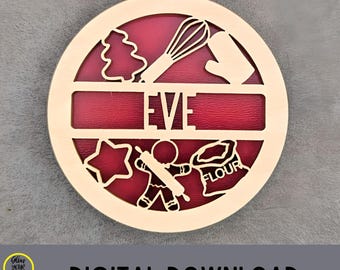 May include: Wooden Christmas ornament with a red background, featuring baking-themed cutouts like a whisk, oven mitt, and gingerbread man. The name "EVE" is displayed prominently. The words "Digital File" and "DIGITAL DOWNLOAD" are also visible.