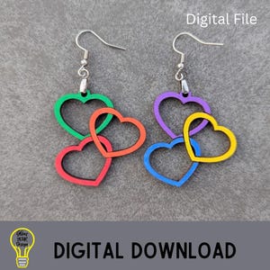 May include: A pair of colorful heart-shaped earrings. Each earring features three interlocking hearts in shades of green, red, orange, purple, blue, and yellow. The earrings have silver-colored hooks and the text "Digital File" and "DIGITAL DOWNLOAD" are visible.