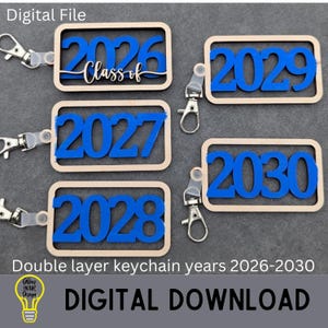 May include: Keychains with the years 2026, 2027, 2028, 2029, and 2030 in blue, set within a light brown rectangular frame. The keychain design includes a clasp and the words "Class of" on the 2026 keychain. The text "Digital Download" is also visible.