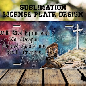 May include: Sublimation design for a license plate featuring a woman kneeling in prayer with a cross on a hill in the background. The text reads "With God by my side No Weapon formed against me Shall Prosper". The design is 12 inches by 6 inches and 300 DPI.