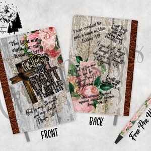 May include: A white journal with a wood grain background and floral accents. The front cover features the text "This is how I fight my battles" with bible verses. The back cover features bible verses and the text "I was created for just a time as this".
