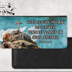 May include: A black leather wallet with a colorful design featuring a woman kneeling on a mountain with a cross on top. The design includes the text "WITH GOD BY MY SIDE NO WEAPON FORMED AGAINST ME SHALL PROSPER ISAIAH 54:17".