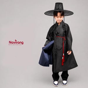 May include: A black traditional Korean hanbok robe with a matching wide-brimmed black hat, featuring a red waist tie with tassels and a long beaded necklace. The garment includes a navy blue inner layer and the text Navirang WITH BUTTERFLIES.
