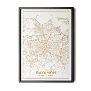 May include: Framed map art of Bayamón, Puerto Rico, in a minimalist style. The map features detailed street and geographical outlines in a warm gold color against a white background. The city name and coordinates are printed at the bottom.