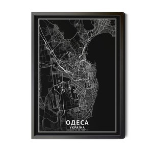 May include: A framed black and white map of Odesa, Ukraine. The map features detailed white lines representing streets and infrastructure against a black background. The city's name, in Cyrillic and English, and coordinates are displayed at the bottom.