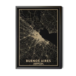 May include: A framed map print of Buenos Aires, Argentina, in a black frame. The map features a detailed gold-colored depiction of the city's streets and infrastructure against a black background. The city name and coordinates are printed at the bottom.