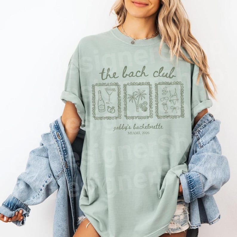 May include: A light green t-shirt with the text "the bach club" and "gabby's bachelorette, Miami, 2020". The shirt features three framed illustrations of a champagne bottle, cocktail, palm trees, and swimwear.