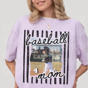 May include: A light purple t-shirt featuring a baseball-themed design. The design includes the word "baseball" in a script font, a photo of a child in a baseball uniform, the number "4", and the word "mom".